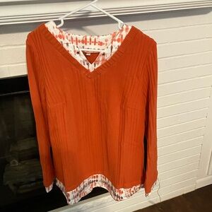 Pumpkin colored, long sleeved sweater.  Size L